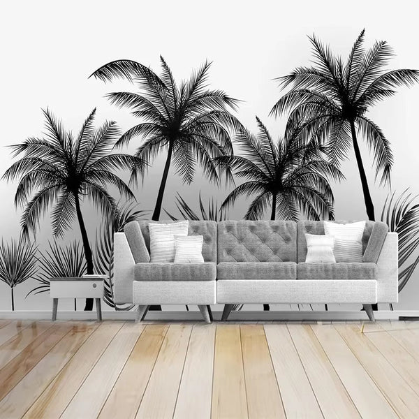 Papier peint panoramique palmiers Palmeraie à l'encre, noir et blanc, derrière un canapé