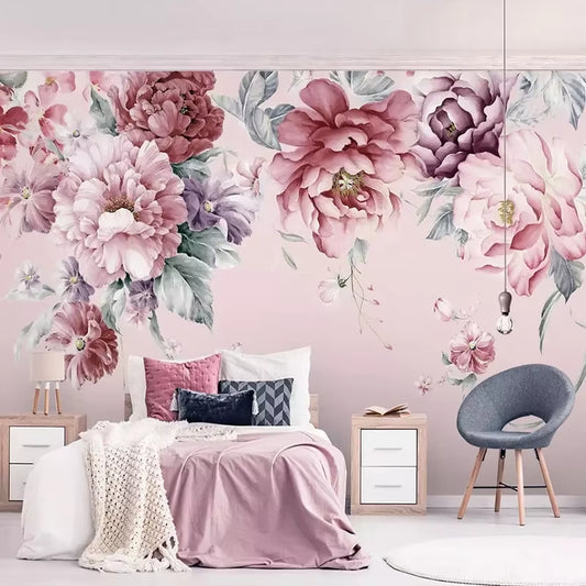 Papier peint panoramique Pivoines de mai derrière un lit, linge rose et blanc, fauteuil gris et chevet blanc