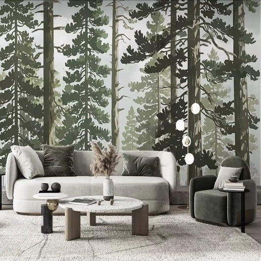 Papier peint panoramique La Grande Pinède dans un salon, canapé bouclé blanc, fauteuil vert et tables basses en travertin