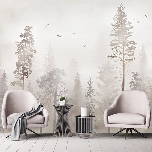 Papier peint panoramique Pinède à l'aube derrière deux fauteuils rose poudré, tables d'appoint en métal et plaid gris